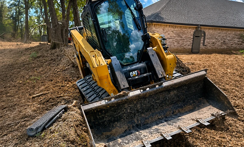 Excavator Performing Drainage Improvements Near House With Piping in Waco TX