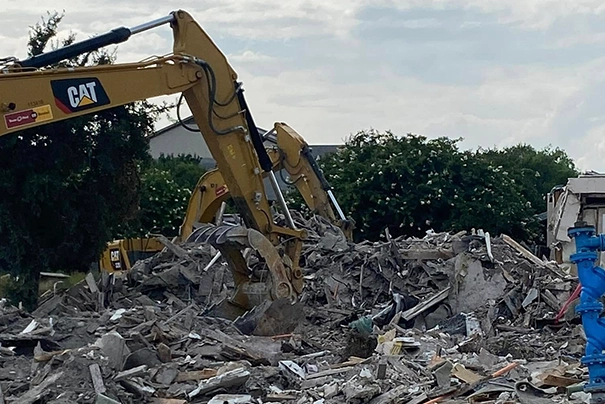 Excavators Performing Demolition Services in Waco TX Amidst Concrete Rubble